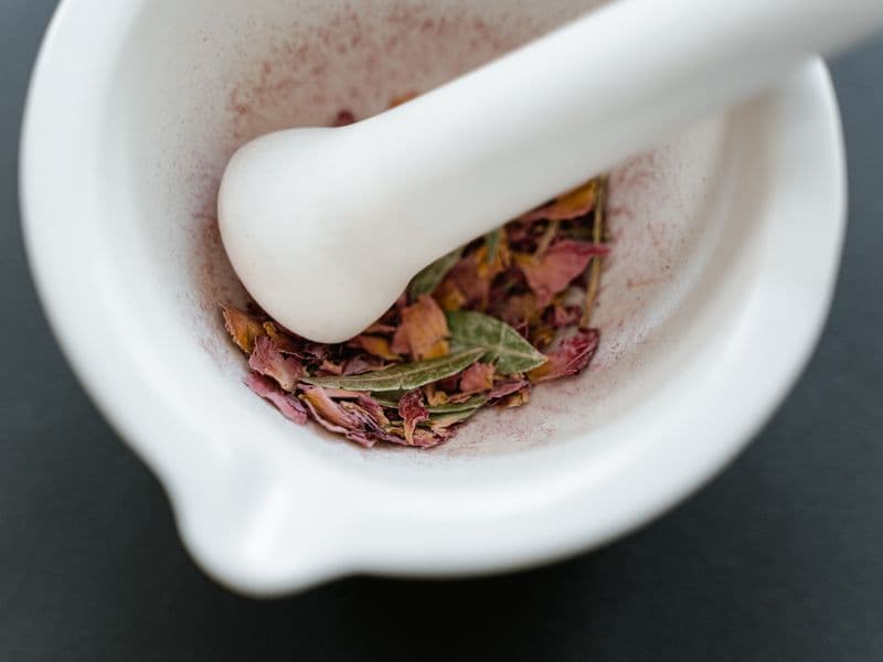 Dried herbal petals in a mortar and pestle